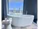 Luxurious bathroom with a freestanding tub and panoramic city views at 4381 W Flamingo Rd # 2022, Las Vegas, NV 89103