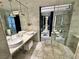 Marble-tiled bathroom with double sinks, pendant lighting, and a walk-in shower at 4381 W Flamingo Rd # 2022, Las Vegas, NV 89103