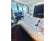 Modern bedroom featuring a luxurious king-size bed, city views, and a stylish bathtub near the window at 4381 W Flamingo Rd # 2022, Las Vegas, NV 89103