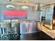 Modern kitchen featuring stainless steel appliances, island with seating, and unique pendant lighting at 4381 W Flamingo Rd # 2022, Las Vegas, NV 89103