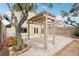Charming backyard with a patio cover, mature trees, and desert landscaping, offering tranquility and natural beauty at 4552 Aviation St, Las Vegas, NV 89115