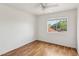 A bedroom featuring a ceiling fan, wood-look flooring and natural light at 4552 Aviation St, Las Vegas, NV 89115