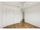 Bright bedroom features wood-look floors, a ceiling fan, and a closet for storage at 4552 Aviation St, Las Vegas, NV 89115
