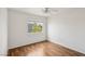 A bedroom featuring a ceiling fan, wood-look flooring and neutral paint at 4552 Aviation St, Las Vegas, NV 89115
