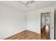 Bedroom featuring a ceiling fan, wood-look floors, and a closet for ample storage space at 4552 Aviation St, Las Vegas, NV 89115