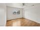 Bright bedroom with wood-look flooring, window, and ample closet space at 4552 Aviation St, Las Vegas, NV 89115