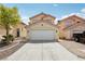 Front view of a two-story home with a well-manicured yard and spacious two-car garage at 4552 Aviation St, Las Vegas, NV 89115