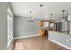 Open kitchen and dining area with wood-look floors and stainless steel appliances at 4552 Aviation St, Las Vegas, NV 89115