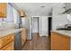 Kitchen featuring granite countertops, stainless steel appliances, and wood-look flooring at 4552 Aviation St, Las Vegas, NV 89115