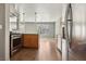 Open kitchen with stainless steel appliances and wood-look tile flooring at 4552 Aviation St, Las Vegas, NV 89115