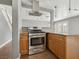 Kitchen with granite counters, stainless steel range and wood-look flooring at 4552 Aviation St, Las Vegas, NV 89115