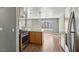 Modern kitchen with granite counters, stainless steel appliances, and wood-look floors at 4552 Aviation St, Las Vegas, NV 89115