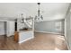 Open floor plan featuring wood-look flooring and granite kitchen island at 4552 Aviation St, Las Vegas, NV 89115