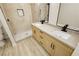 Updated bathroom boasting double sinks, quartz countertops, wood cabinets, and a tiled shower at 4810 Grey Wolf Ln # 104, Las Vegas, NV 89149