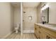 Remodeled bathroom featuring a quartz countertop, wood cabinets, and tiled shower at 4810 Grey Wolf Ln # 104, Las Vegas, NV 89149