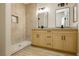 Spa-like bathroom featuring a double vanity, modern fixtures, tile flooring, and walk in shower at 4810 Grey Wolf Ln # 104, Las Vegas, NV 89149