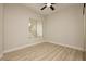 Light-filled bedroom with wood-look floors, a ceiling fan, and a window with blinds at 4810 Grey Wolf Ln # 104, Las Vegas, NV 89149