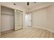 Charming bedroom featuring wood-look floors, a ceiling fan, and sliding mirror closet doors at 4810 Grey Wolf Ln # 104, Las Vegas, NV 89149