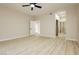 Large bedroom featuring wood-look floors, a ceiling fan, and access to a closet and bathroom at 4810 Grey Wolf Ln # 104, Las Vegas, NV 89149