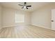 Inviting bedroom with wood-look floors, a ceiling fan, and a bright window at 4810 Grey Wolf Ln # 104, Las Vegas, NV 89149