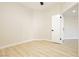 Bright bedroom featuring wood-look floors and a white door leading to another room at 4810 Grey Wolf Ln # 104, Las Vegas, NV 89149