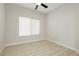 Minimalist bedroom with bright natural light, a neutral color scheme, and laminate floors at 4810 Grey Wolf Ln # 104, Las Vegas, NV 89149
