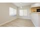 Bright dining area with laminate floors, pendant lighting, and large windows at 4810 Grey Wolf Ln # 104, Las Vegas, NV 89149