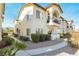 Desirable townhouse with stucco exterior, stone landscaping, private balcony, and inviting walkway at 4810 Grey Wolf Ln # 104, Las Vegas, NV 89149