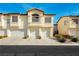 Charming townhome featuring attached garages, beautiful architecture, and well-maintained landscaping at 4810 Grey Wolf Ln # 104, Las Vegas, NV 89149