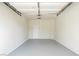 Clean, spacious two-car garage featuring epoxy flooring and a convenient interior access door at 4810 Grey Wolf Ln # 104, Las Vegas, NV 89149