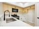 Well-lit kitchen boasts stainless steel sink, black fixtures, and plenty of counter space at 4810 Grey Wolf Ln # 104, Las Vegas, NV 89149