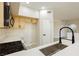 Updated kitchen with stainless steel sink, oven, range, and white quartz countertops at 4810 Grey Wolf Ln # 104, Las Vegas, NV 89149