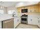 Updated kitchen with stainless steel appliances, range, and white cabinets at 4810 Grey Wolf Ln # 104, Las Vegas, NV 89149
