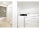 Bright laundry area with washer, dryer, and white storage cabinets at 4810 Grey Wolf Ln # 104, Las Vegas, NV 89149