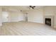 Bright and airy living room featuring new floors, fireplace, open layout and a ceiling fan at 4810 Grey Wolf Ln # 104, Las Vegas, NV 89149