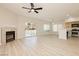 Open-concept living room with fireplace, sliding doors, and kitchen view at 4810 Grey Wolf Ln # 104, Las Vegas, NV 89149