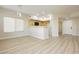 Modern living room with wood-look floors leading to the kitchen with breakfast bar at 4810 Grey Wolf Ln # 104, Las Vegas, NV 89149