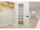 Kitchen pantry features shelving, white walls and laminate flooring at 4810 Grey Wolf Ln # 104, Las Vegas, NV 89149