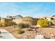 Painted Desert community entrance featuring a wall with desert landscaping and signage at 4810 Grey Wolf Ln # 104, Las Vegas, NV 89149