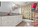 This bathroom features a modern vanity, shower with custom curtain and updated fixtures at 5004 Cannon Blvd, Las Vegas, NV 89108
