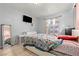 Bright bedroom with colorful floral bedspread, window, and tile flooring at 5004 Cannon Blvd, Las Vegas, NV 89108
