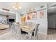 Dining room with a glass-top table, six chairs, and contemporary wall art at 5004 Cannon Blvd, Las Vegas, NV 89108