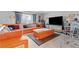 Comfortable living room boasts an orange sectional sofa and modern decor at 5004 Cannon Blvd, Las Vegas, NV 89108