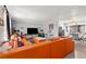 Bright living room featuring a large orange sectional sofa and neutral walls at 5004 Cannon Blvd, Las Vegas, NV 89108