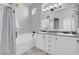A bright bathroom featuring a tiled tub, shower, and double sink vanity with great natural light at 509 Regal Robin Way, North Las Vegas, NV 89084