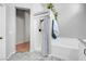 A bathroom featuring a shower with glass doors, a tiled bathtub, and a modern vanity at 509 Regal Robin Way, North Las Vegas, NV 89084