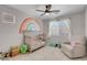 Bedroom room with crib, comfy chair, and rainbow decor creating a playful atmosphere at 509 Regal Robin Way, North Las Vegas, NV 89084