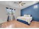 Cozy bedroom featuring a blue accent wall, plush bedding, and ample natural light at 509 Regal Robin Way, North Las Vegas, NV 89084