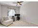 Bright bedroom with a ceiling fan, a comfortable chair, and an office desk setup at 509 Regal Robin Way, North Las Vegas, NV 89084