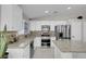 Bright kitchen with white cabinets, granite countertops, stainless steel appliances, and tile flooring at 509 Regal Robin Way, North Las Vegas, NV 89084